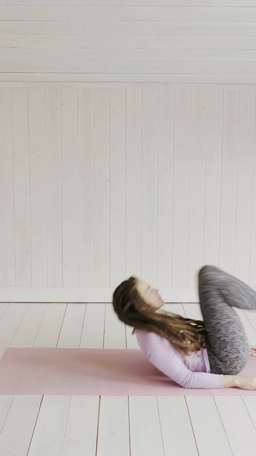 Woman Doing Exercises With Legs Up In The Air