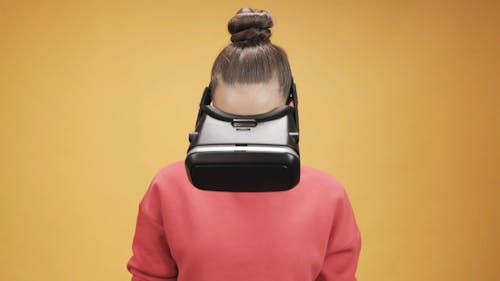 Woman In Pink Sweatshirt Using A Virtual Reality