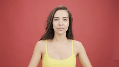 A Woman In Yellow Top Wrapping A Yellow Sweatshirt Around Her Shoulders