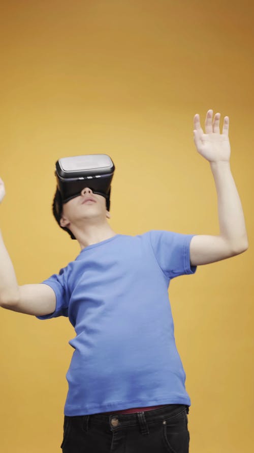 Man In Blue Shirt Using Virtual Reality