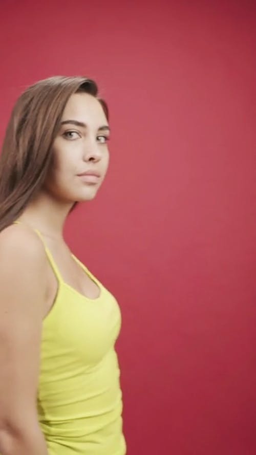 Side View Of A Woman In A Yellow Sleeveless Shirt 