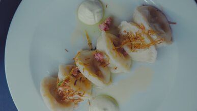 delicious gourmet dumplings on white plate