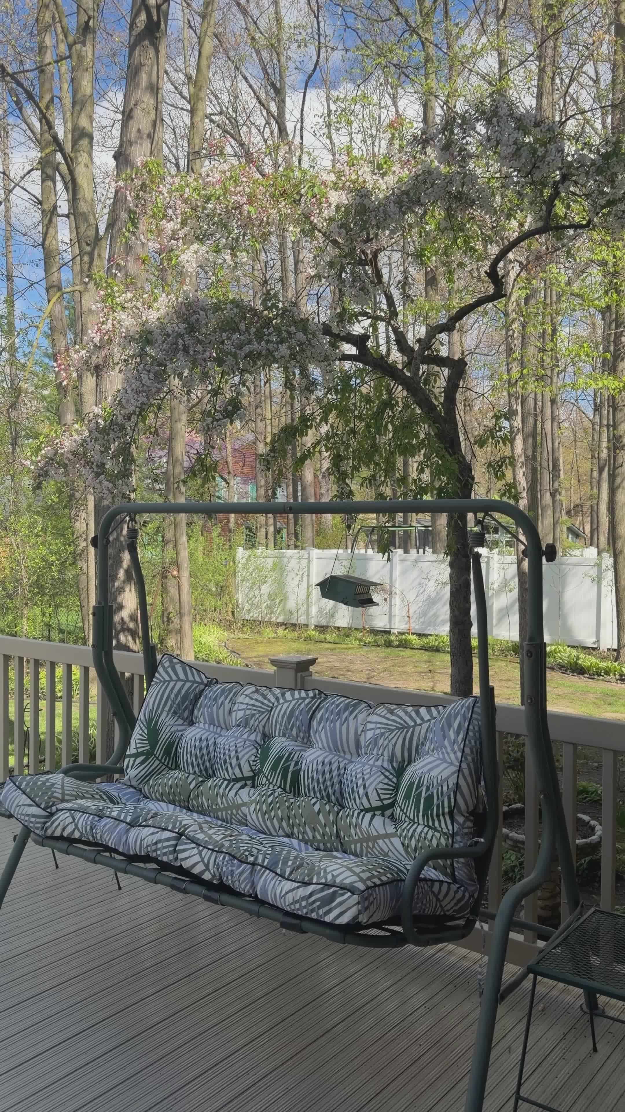 cozy springtime outdoor swing on wooden deck 37674763