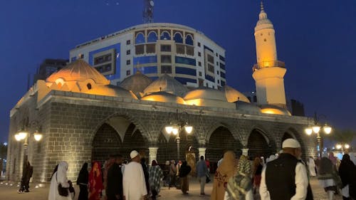 People Walking Outside a Mosque