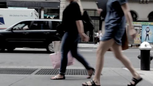 Cars Passing By and People Walking at a Street in New York