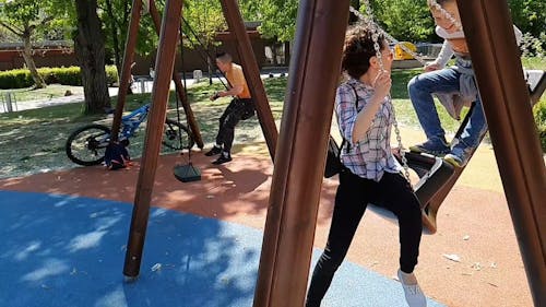 Using The Swing In The Playground For Fun