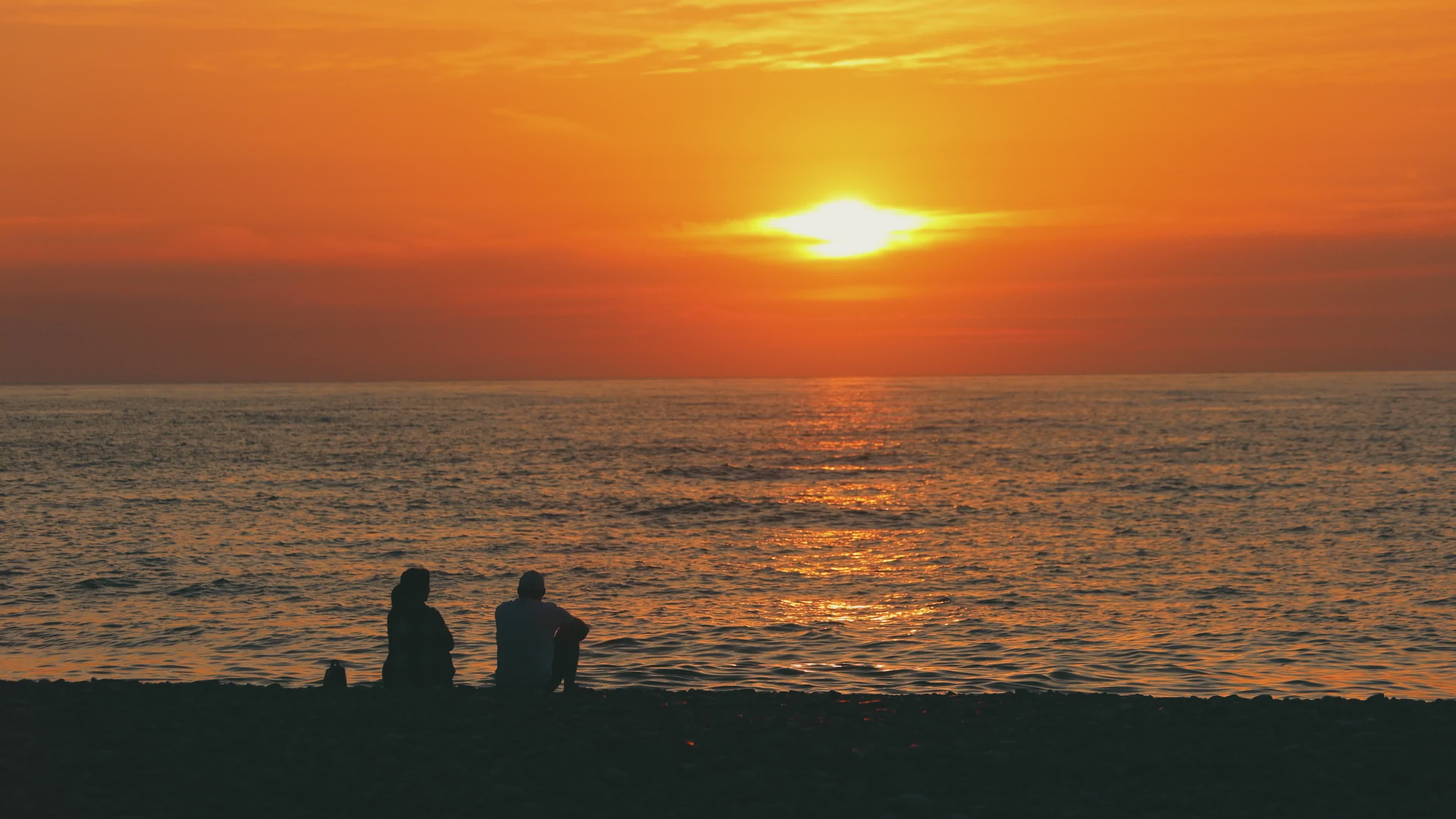 Peaceful Beach Sunset with Silhouetted Figures Free Stock Video Footage ...