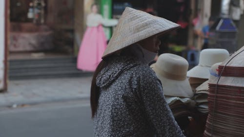 People On Motorcycles And Merchants On A Busy Street