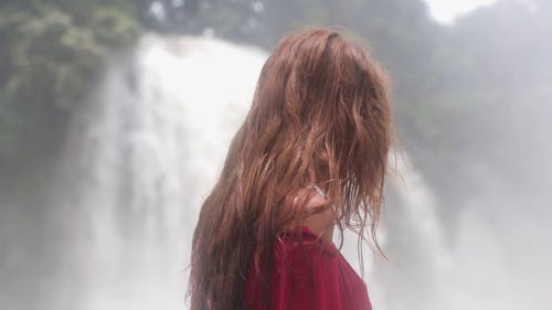 Backside Of A Woman Watching The Waterfalls