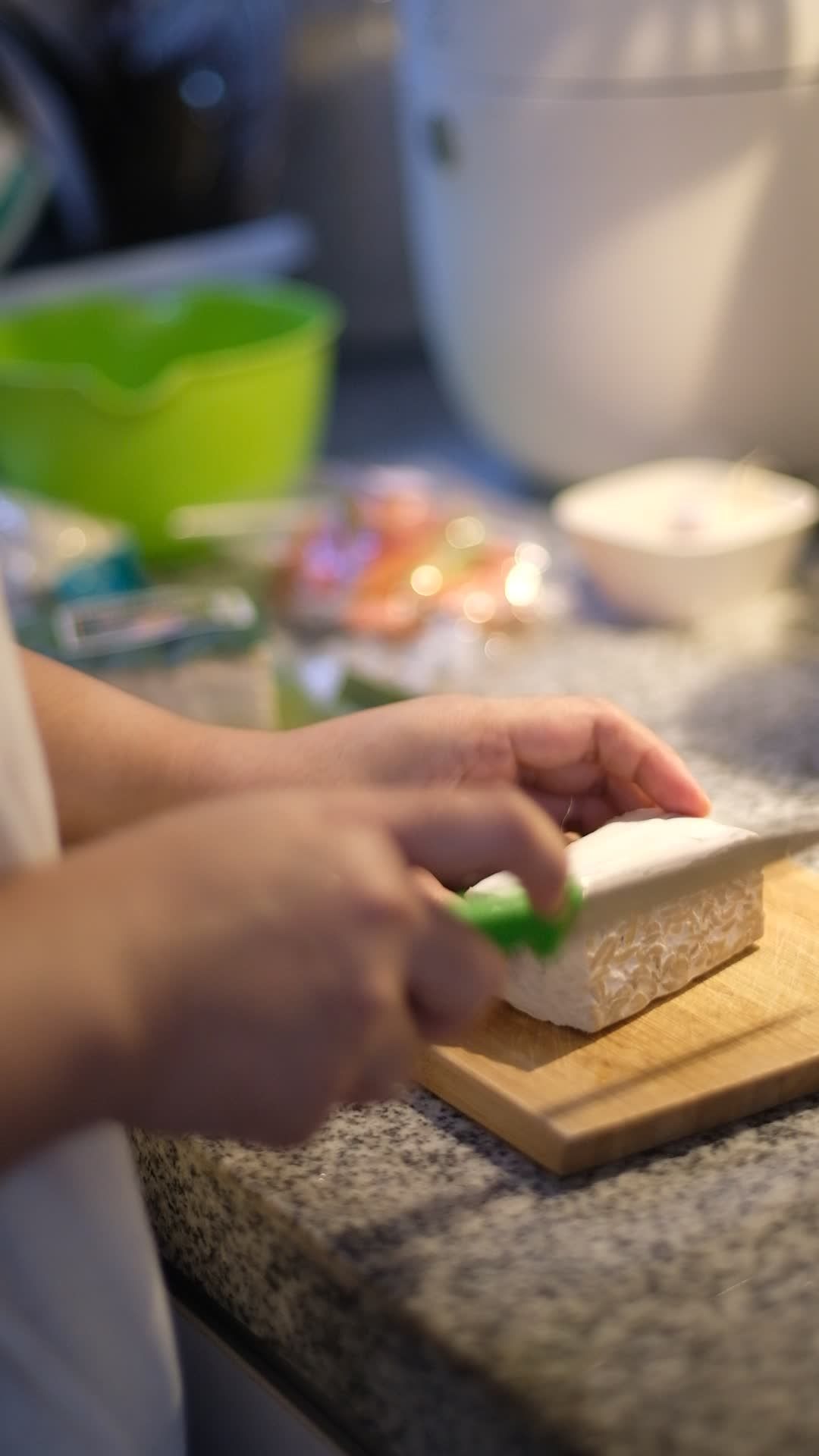 artisan cooking slicing tofu in a cozy kitchen 37876540
