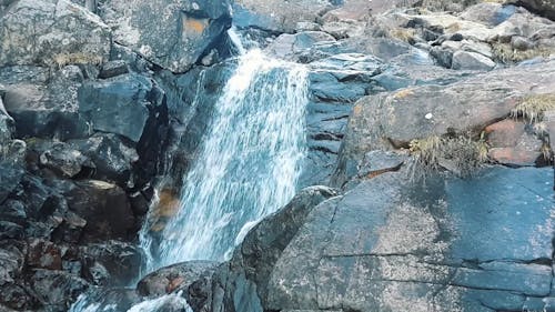 A Waterfall Cascading Down Layers Of Rock