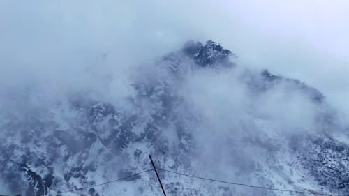 Thick Fogs Covering The View Of The Mountain Summit