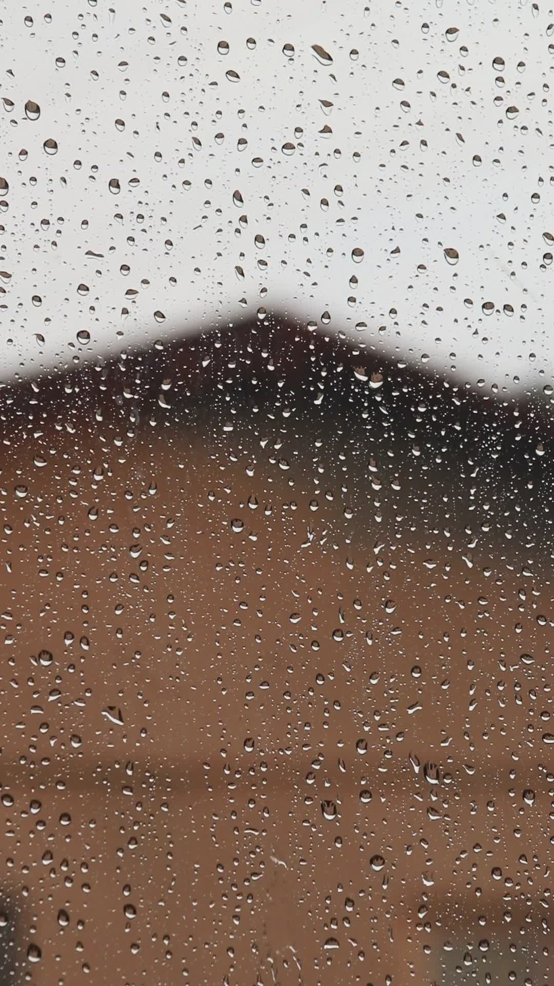 raindrops on window with blurred building 37925060 — free pexels stock footage