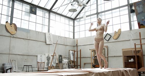 A Woman In Her Underwear Dancing Inside A Studio