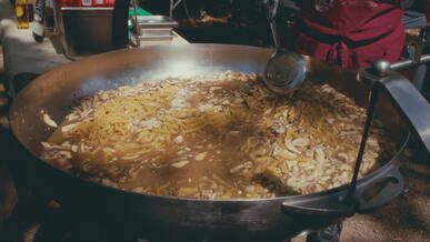 large outdoor mushroom pasta dish in preparation