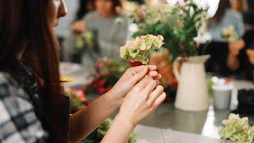 Woman Wiring Flowers For Decoration