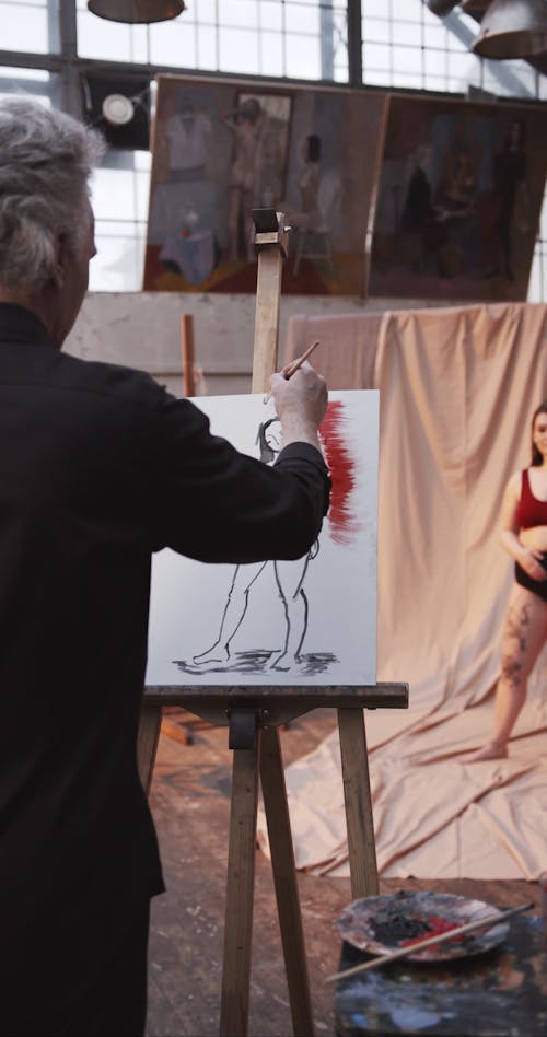 Footage Of A Painter Focusing On Her Subject