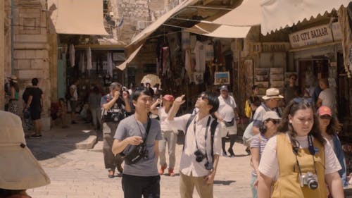 A Crowd Of Tourists In A Busy Street Of Jerusalem