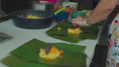 making traditional tamales on banana leaves