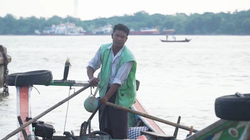 A Man Rowing a Boat in the Yangon River