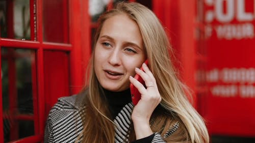 Woman Using A Red Smartphone