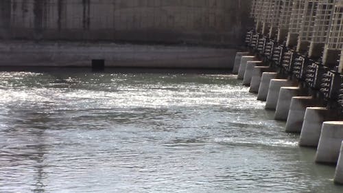 River Water Flowing From The Dam Gates