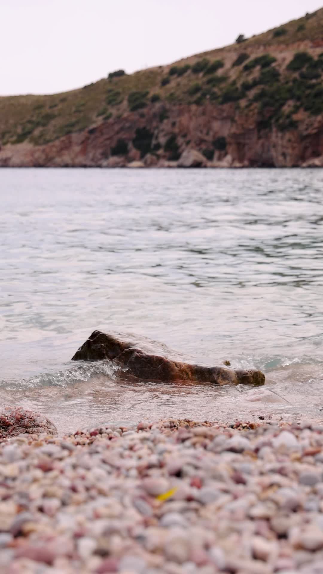 calm waves gently hitting rocky shoreline 38272135 — free pexels stock footage