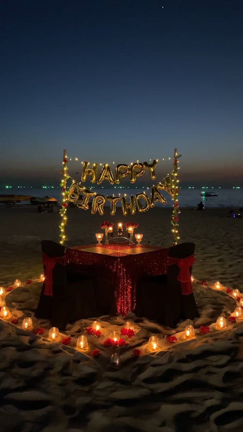 A Birthday Dinner Set Up for Two by the Beach