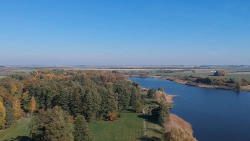 Landing A Drone Machine On A Park Beside A Lake