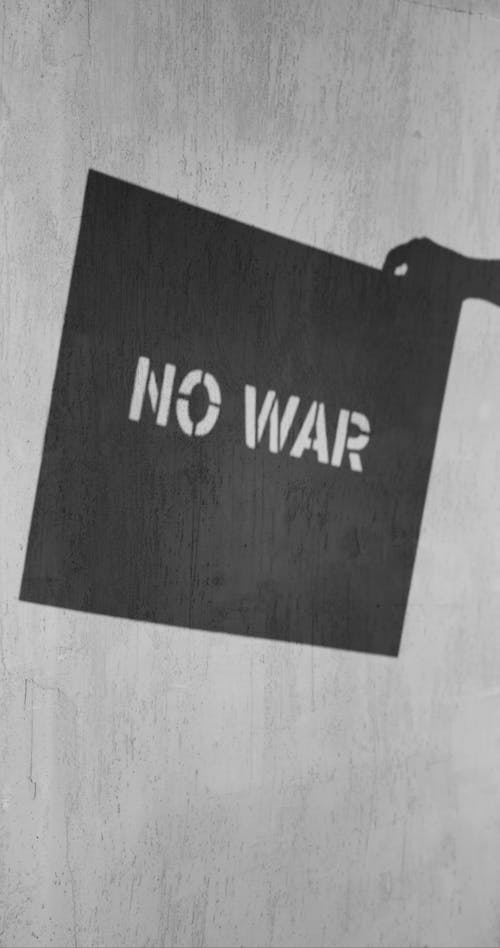 Stencil Board Show A "NO WAR' Statement From Its Projected Shadow Off The Wall