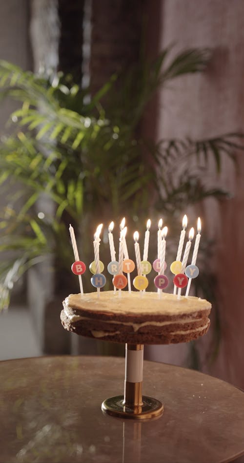 A Single Missed Candle Unlit Among A Set Lighted On a Birthday Cake