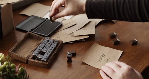 Stamping Words Of Wishes On Paper Using Letter Rubber Stamps