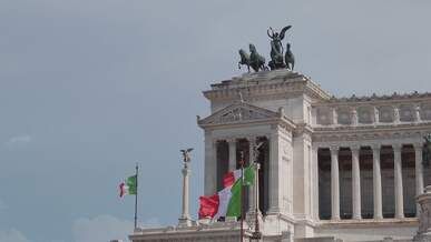 vittoriano monument with italian flags in rome