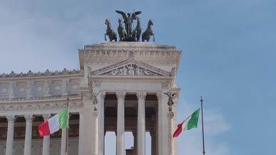 vittoriano monument with italian flags in rome