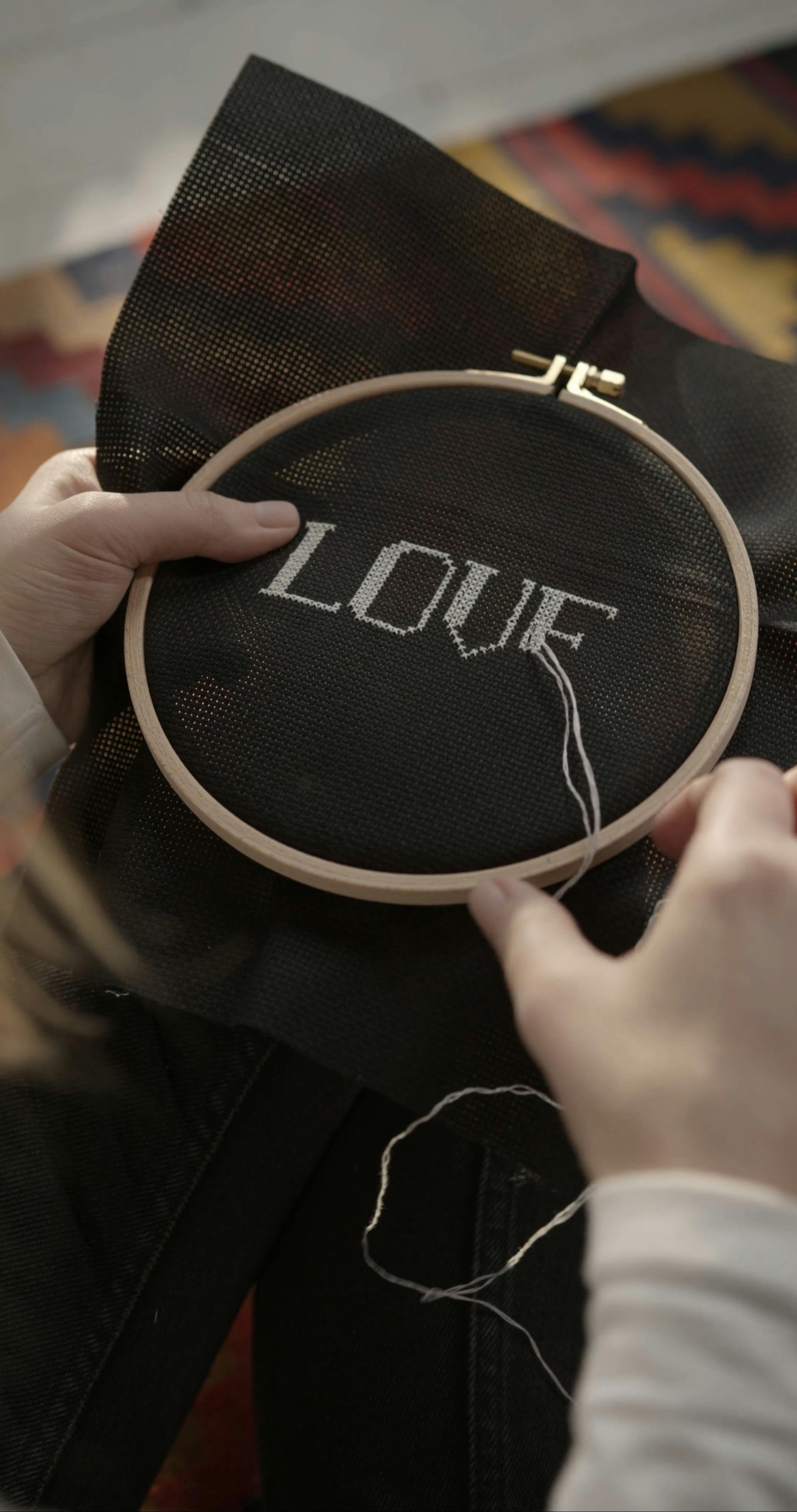 Cross Stitching On A Black Aida Cloth · Free Stock Video