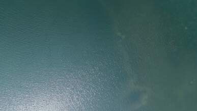 aerial view of boat on serene blue ocean