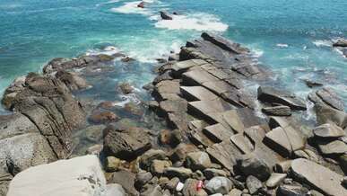 aerial view of rocky coastline and ocean waves