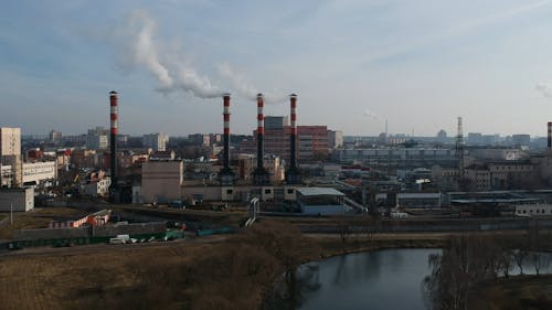 Drone Footage Of A Manufacturing Plant With Smoking Chimneys