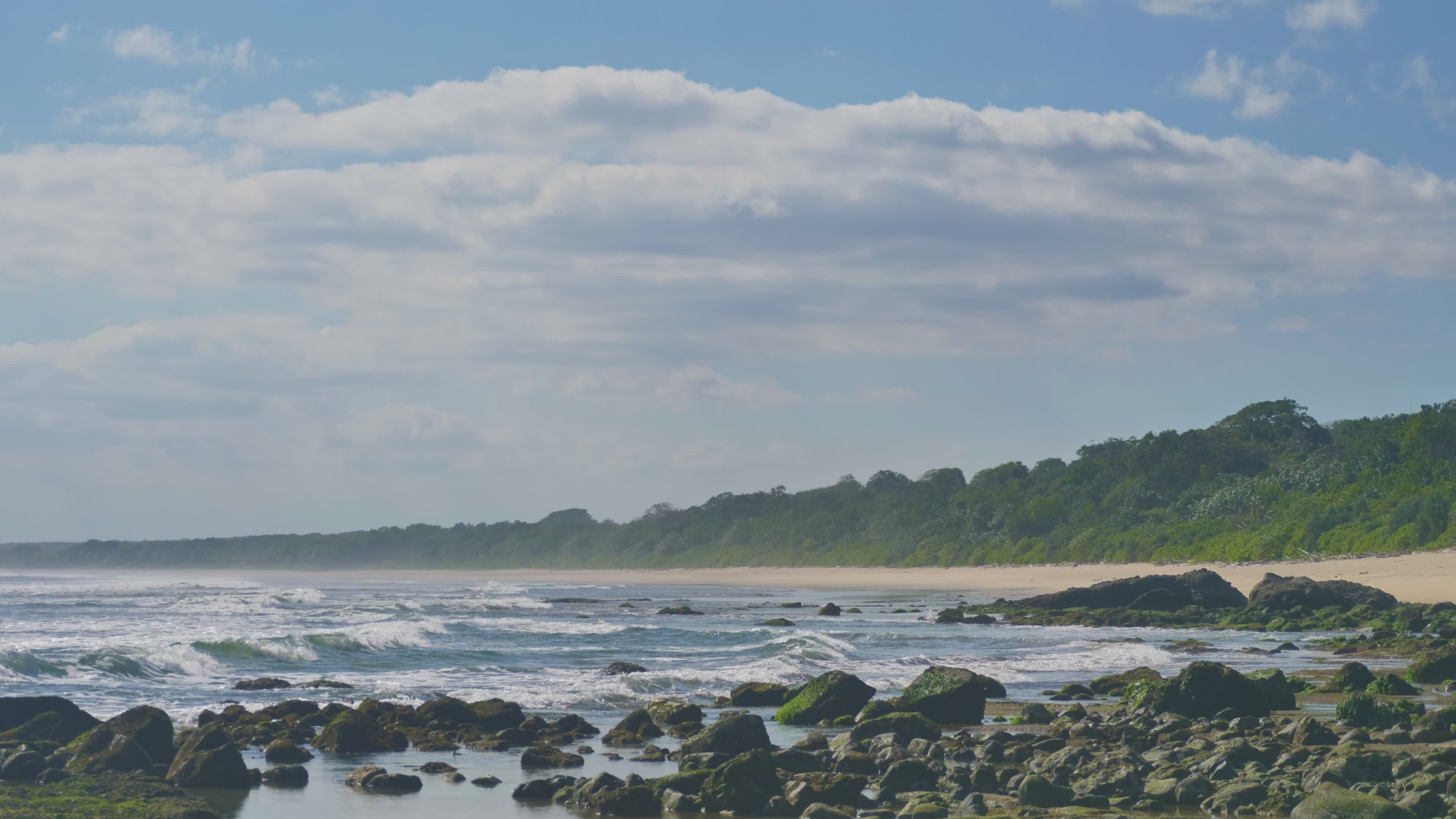 tranquil coastal beach with rocky shoreline 38610215 — free pexels stock footage