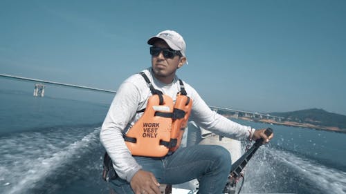 Medium Shot of a Man Operating a Boat