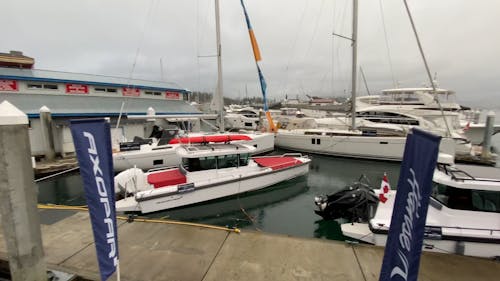 Panning Shot of Docked Boats by a City