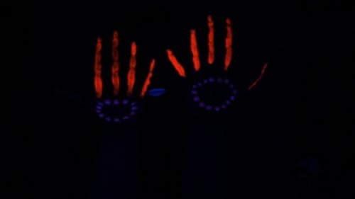 Hands Glowing With Glow In The Dark Paint