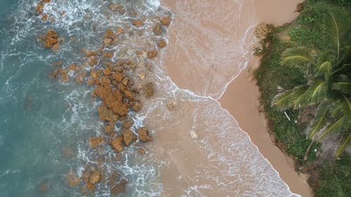 Aerial Shot of Crashing Waves on Rocky Seashore