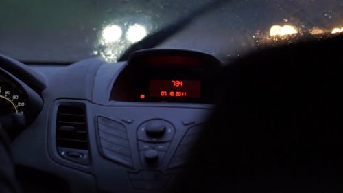 A Person Driving a Car while Raining Wipers on Working on the Windshield