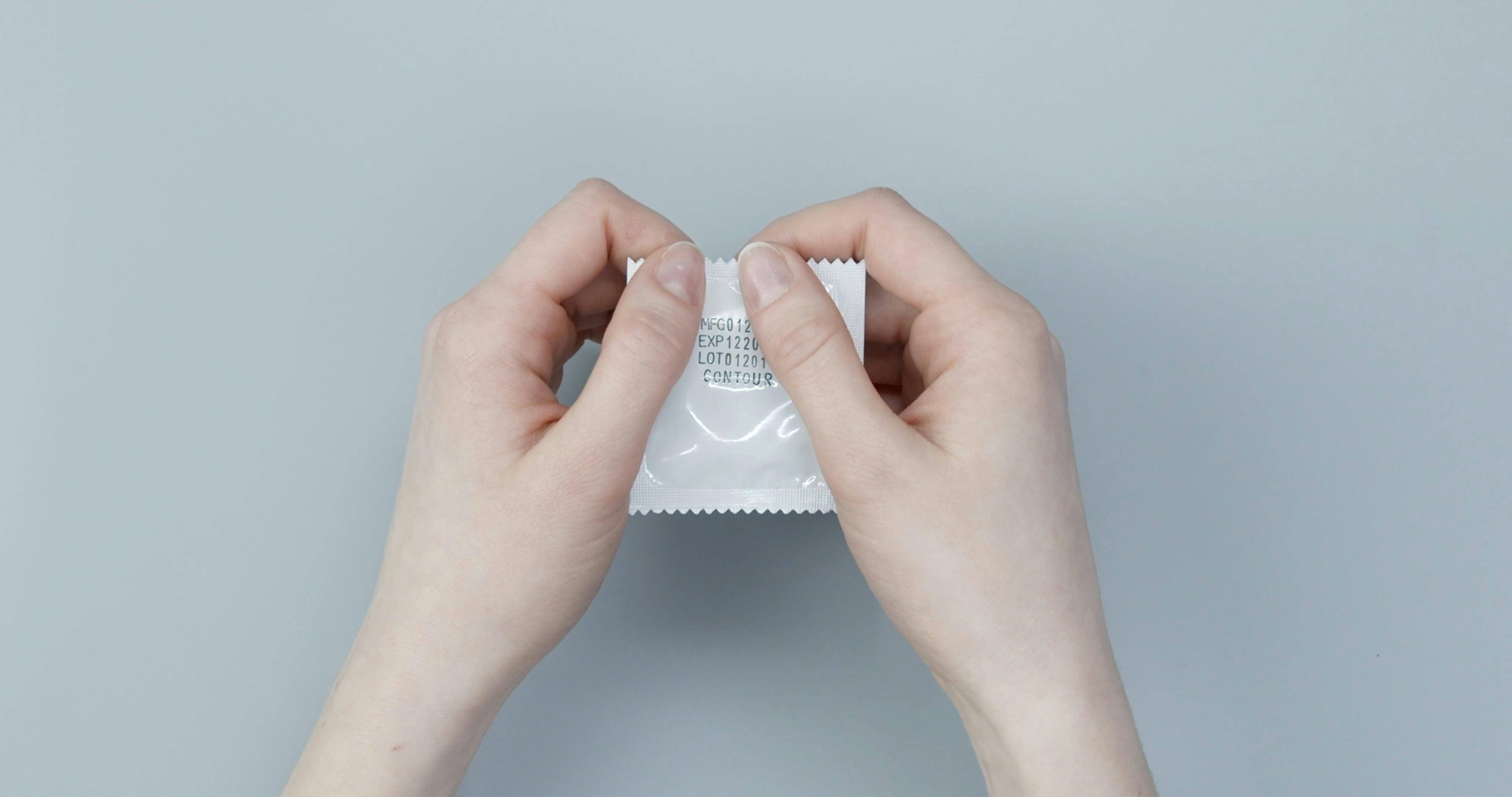 Opening A Sealed Condom · Free Stock Video