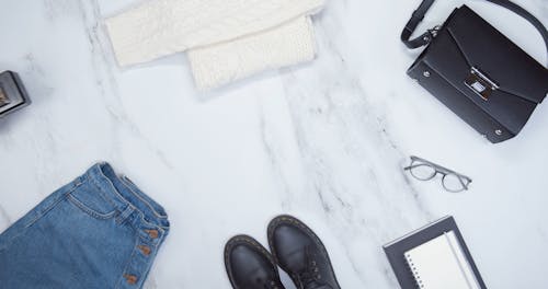 A Person Personal Belongings Placed Over A Marble Top