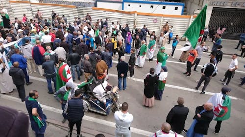 A Crowd Of People Holding A Protest 