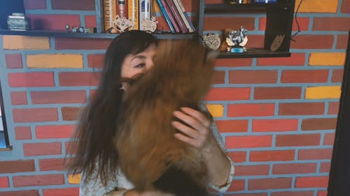 Woman Holding And Kissing Her Cat