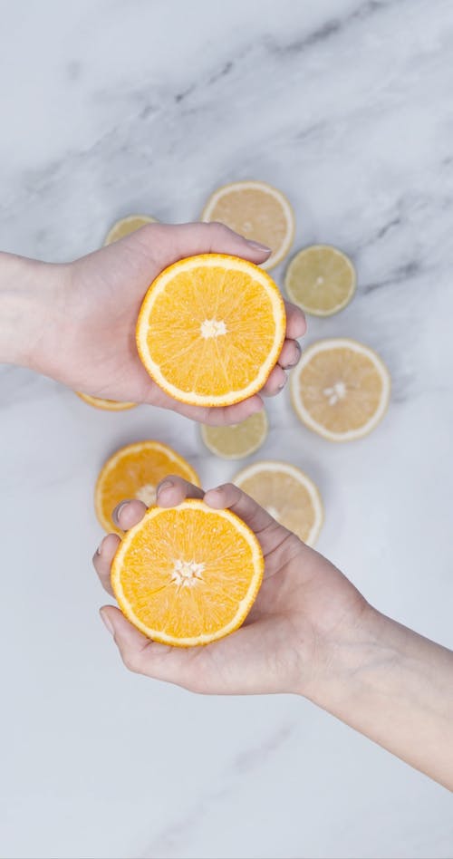 Squeezing By Hand The Slices Of Orange Fruits 