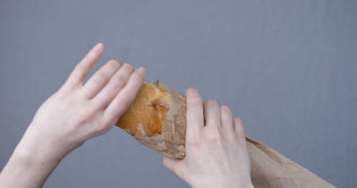 Cutting By Hand A Freshly Baked Baguette